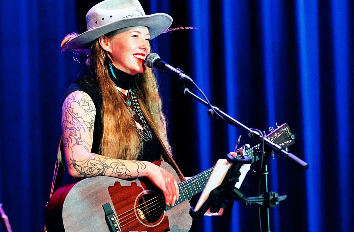 Amelia Presley on stage with guitar